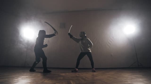Warriors-are-fighting-during-sword-battle-indoors-in-slow-motion