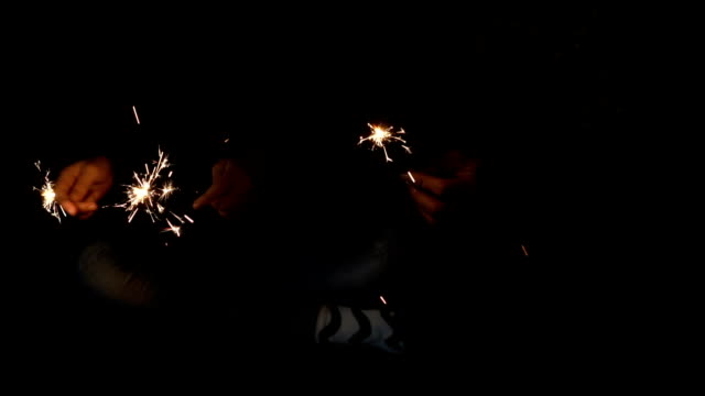 Sparkler-in-hands-mother-and-daughter-on-new-year-party-slow-motion-shot