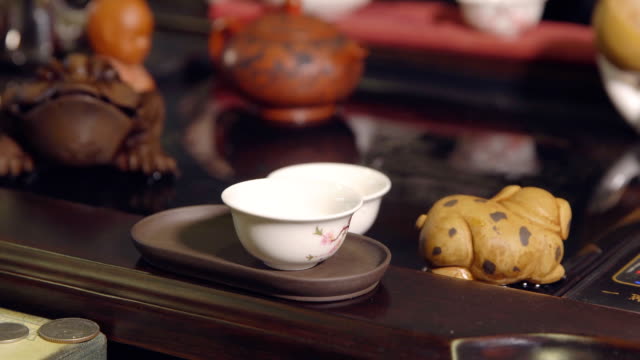Tea-ceremony.-Master-pours-tea-on-white-cups