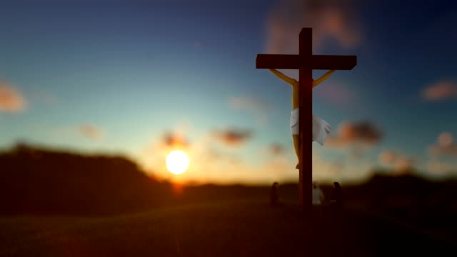 Jesus-on-cross-against-beautiful-blurry-sunset,-believers-praying