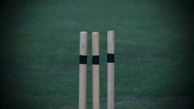 A-Cricket-ball-hits-the-Cricket-stumps-in-slow-motion-knocking-the-bails-off.