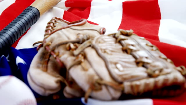 Baseball,-baseball-bat-and--baseball-gloves-on-an-American-flag