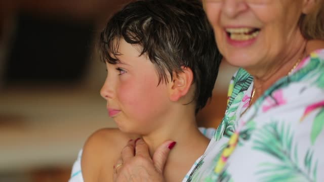 Grand-mother-comforts-crying-child.-Weeping-young-boy-cries.-Candid-authentic-slow-motion-120fps-clip