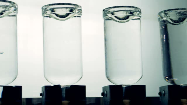 Full-bottles-are-tested-upside-down-on-a-light-background.-4K.