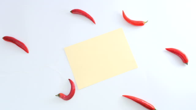 The-chilli-and-piece-of-sheet-is-moving-away-from-the-white-background