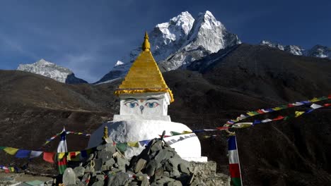 Buddhist-stupa-on-mountain-trekking-path-in-Himalayas,-Nepal.-Crane-shot.-4K,-UHD