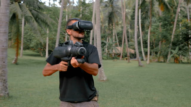 Man-with-weapon-playing-virtual-reality-game-in-the-jungle