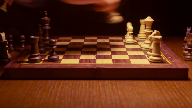 chess-player-making-a-move-in-the-game-on-wooden-table
