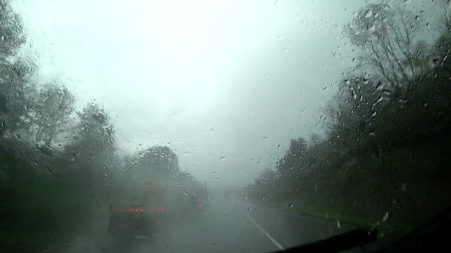El-coche-está-conduciendo-en-lluvia-pesada-en-la-carretera