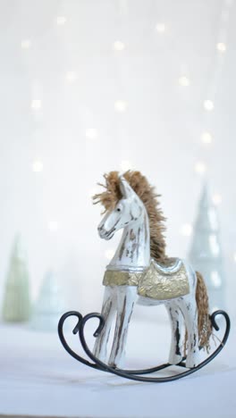 Rocking-toy-horse-with-Christmas-trees-and-led-garland-lights-on-the-back