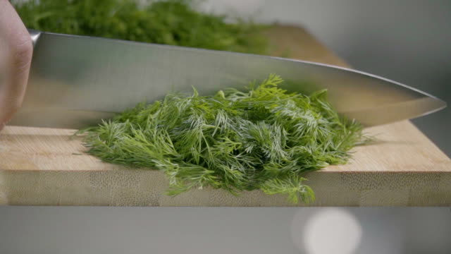 Falling-of-dill-into-the-frying-pan.-Slow-motion-480-fps