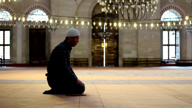 Young-adult-caucasian-man-praying-and-worship-at-the-mosque