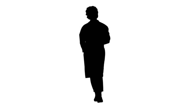 Silhouette-Friendly-female-doctor-walking-and-talking-to-camera