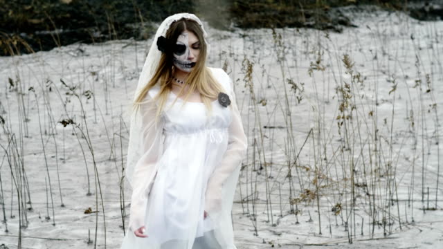 The-young-woman-with-scary-make-up-of-dead-bride-for-Halloween-in-white-dress.-4K