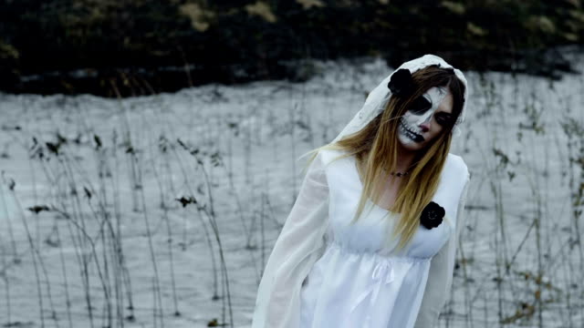 A-woman-with-make-up-of-dead-bride-for-Halloween-in-wedding-gown.-Slow-motion.-HD