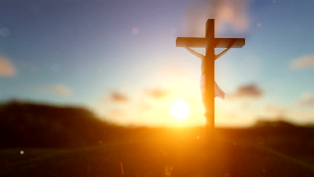 Jesus-on-cross-over-blurry-sunset,-concept-for-religion