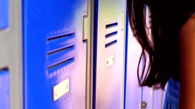 Sad-schoolgirl-leaning-on-lockers-4k