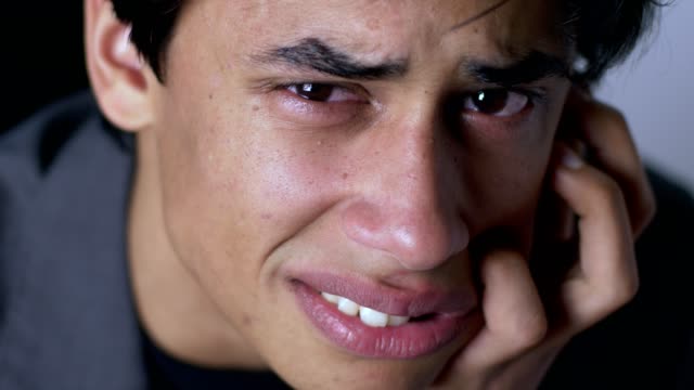Sad-desperate-young-latin-man-crying-looking-at-camera.-Depressione,problems