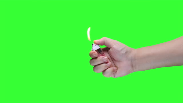 Hand-holding-lighter-on-green-screen-background