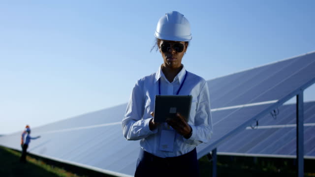 Female-electrical-worker-on-her-tablet-outside