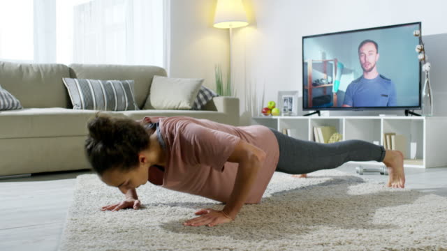 Woman-Doing-Workout-at-Home-with-Online-Fitness-Trainer