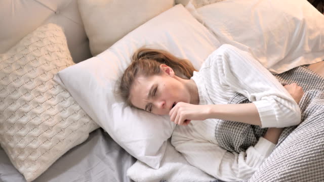 Top-View-of-Coughing-Young-Girl-in-Bed