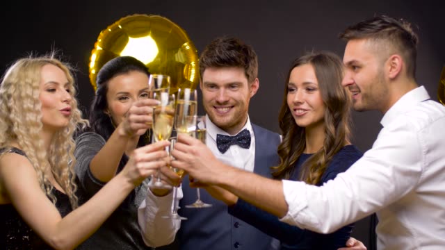 happy-friends-clinking-champagne-glasses-at-party