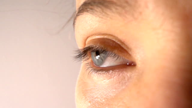 Close-up-of-woman-blue-eye-blinking,-slow-motion
