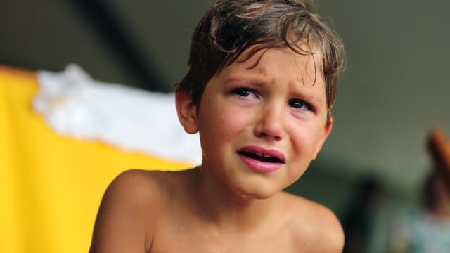 Crying-child-looks-around.-Candid-authentic-120fps-clip-of-young-boy-weeping