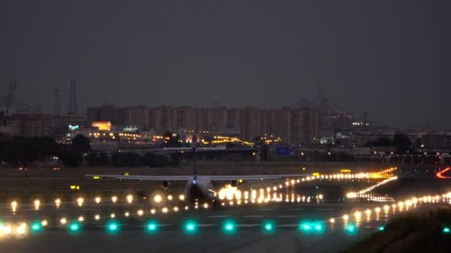 jet-taking-off-at-airport-runway,-rear-view
