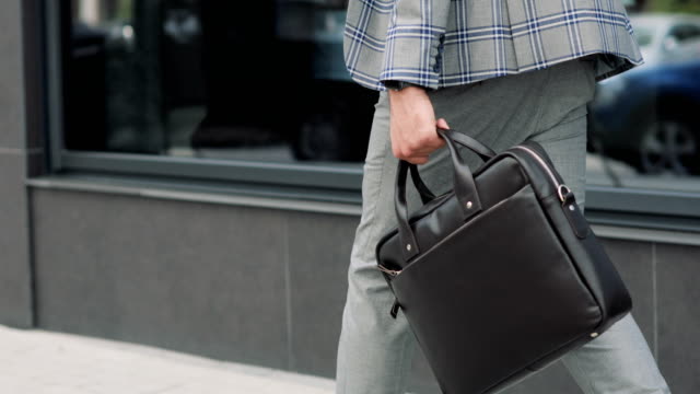 Businessman-with-a-briefcase-Walking-on-Streets-of-Business-District