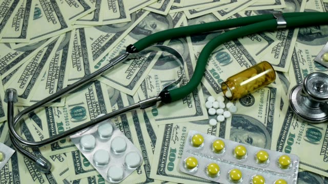 Slider-Shot-Of-Dollar-Bills-And-Medicine-On-The-Table