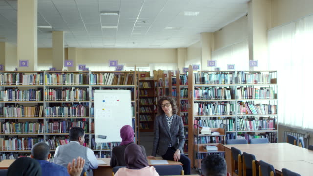 Female-Teacher-Interacting-with-Migrant-Students
