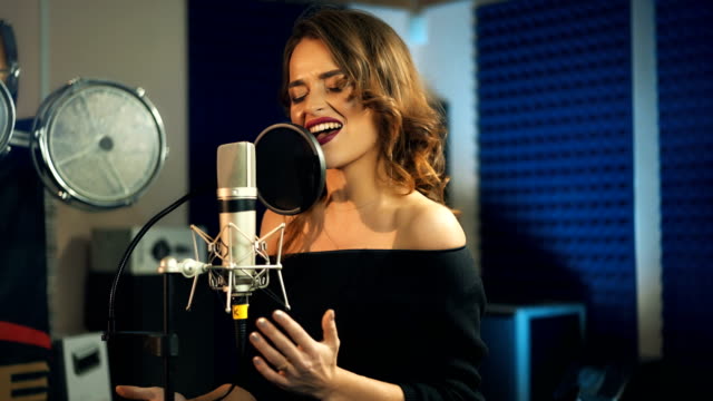 Beautiful-young-singer-who-recorded-a-song-in-a-professional-recording-studio.
