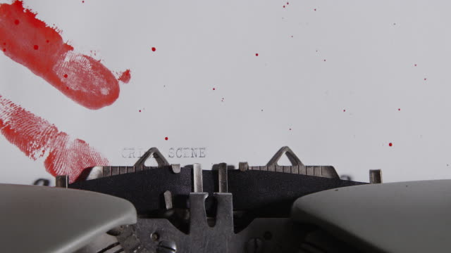 Typewriter-spelling-crime-scene-on-paper-stained-with-bloody-fingerprints