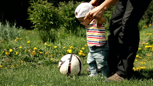 Father-teaches-his-son-to-play-soccer.