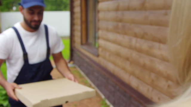 Man-Delivering-Pizza-to-Unrecognizable-Woman