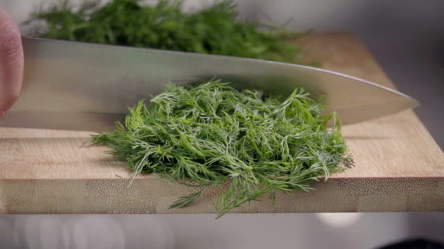 Falling-of-dill-into-the-frying-pan.-Slow-motion-240-fps