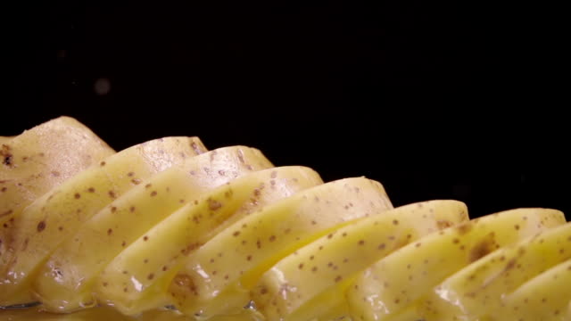 Falling-of-sliced-potatoes-into-the-wet-table.-Slow-motion-240-fps