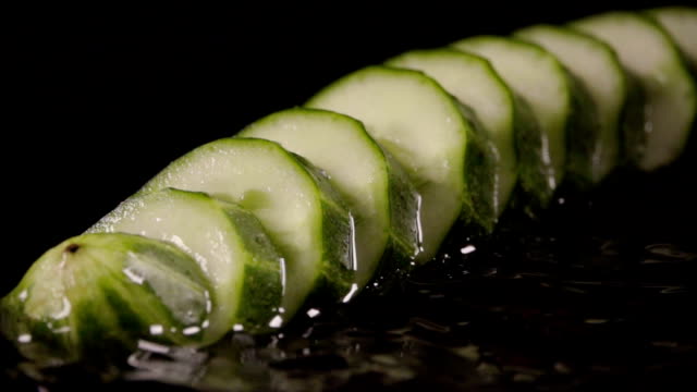 Falling-of-sliced-cucumber-into-the-wet-table.-Slow-motion-240-fps