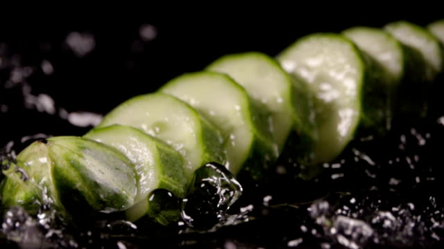 Falling-of-sliced-cucumber-into-the-wet-table.-Slow-motion-480-fps
