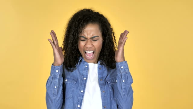Screaming-Angry-African-Girl-Isolated-on-Yellow-Background