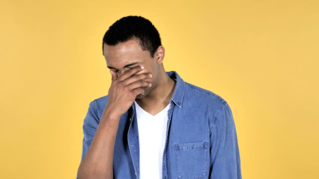 Sad-Upset-Young-African-Man-Isolated-on-Yellow-Background