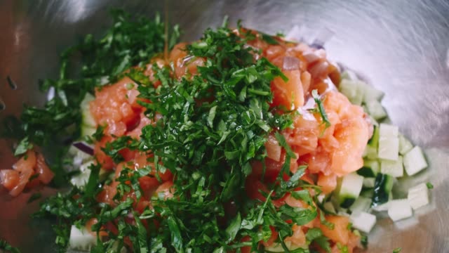 Salad-of-tomato,-cucumber-and-parsley-water-with-oil-in-4k-resolution-in-slowmotion