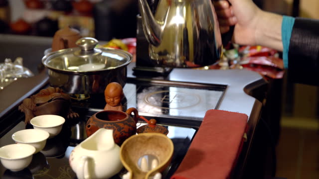 Tea-ceremony.-Tea-maker-pours-boiling-water-into-the-teapot