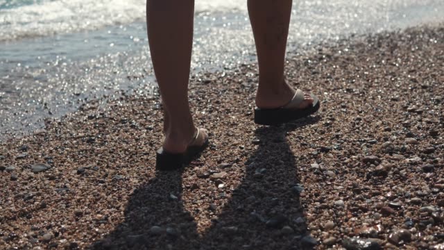 Woman-take-a-walk-along-beach.