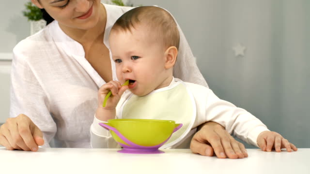 Mother-and-baby-with-bowl-and-spoon