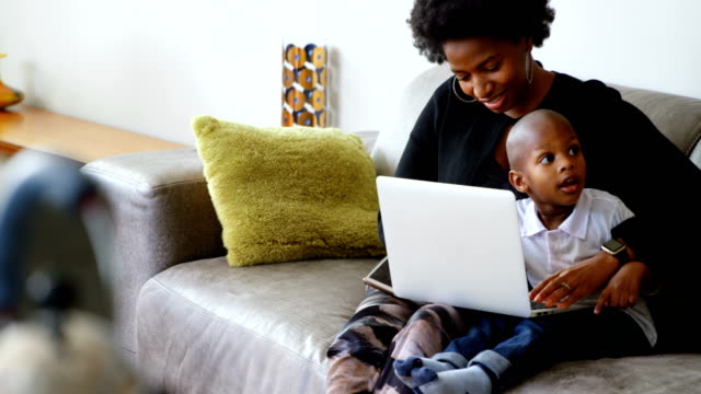 Mother-and-son-using-laptop-in-a-comfortable-home-4k
