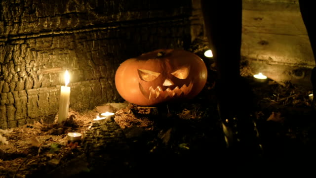 Halloween-pumpkin-head-jack-lantern-with-burning-candles-on-black-background.-HD