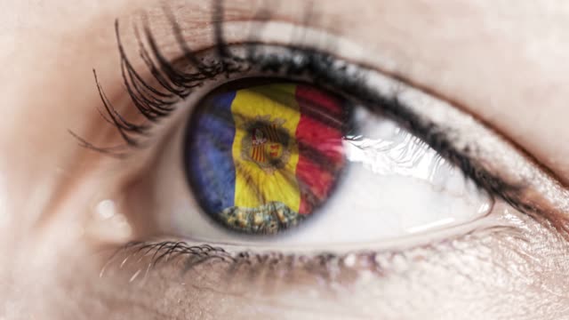 woman-green-eye-in-close-up-with-the-flag-of-Andorra-in-iris-with-wind-motion.-video-concept